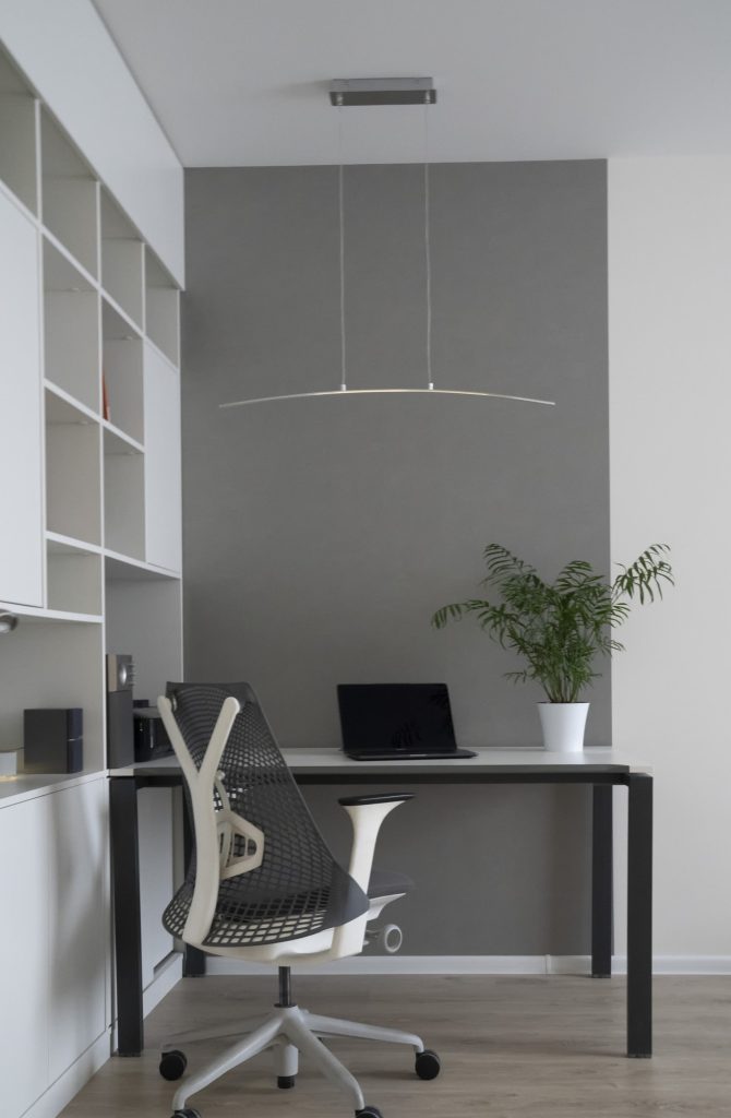 company-office-corner-with-a-modern-desk-orthopedic-chair-up-to-date-computer-and-green-flowerpot.jpg